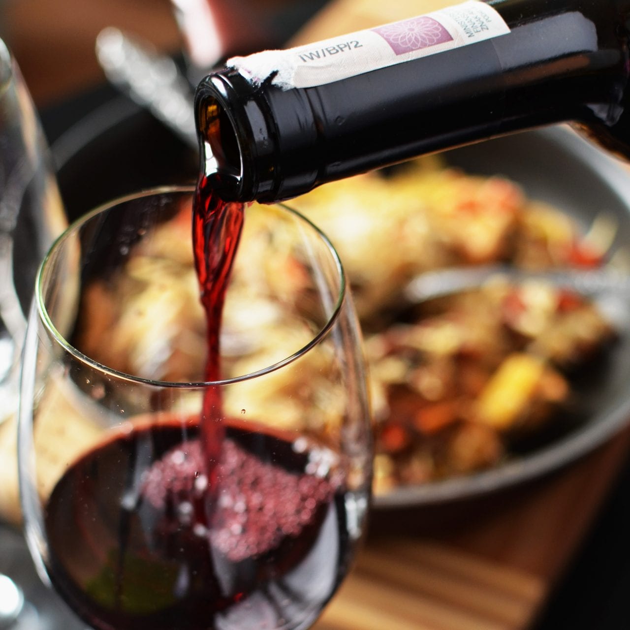 Red wine being poured into a wine glass