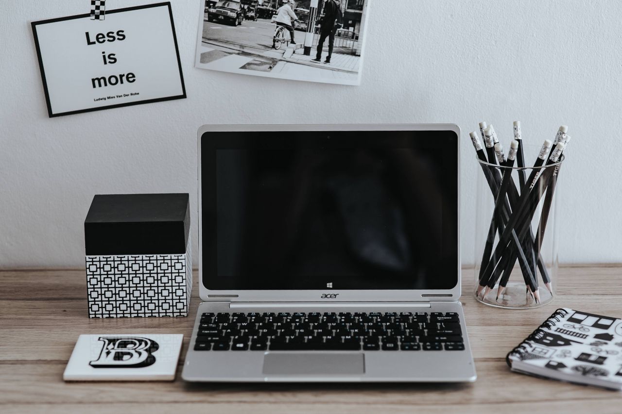 A laptop on a minimally decorated desk