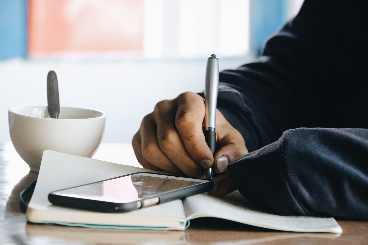 A man writing in a notebook